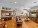 Open concept living room with kitchen, seating, and dining spaces, featuring hardwood floors at 152 Melissa Trl, Auburndale, FL 33823