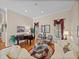 Bright living room featuring a decorative rug, a piano and hardwood floors at 152 Melissa Trl, Auburndale, FL 33823