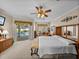 Well-lit main bedroom featuring ceiling fan, sitting area, and sliding glass doors to the outdoor pool area at 152 Melissa Trl, Auburndale, FL 33823