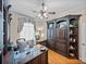 Home office with custom built-in shelves, wood desk, and hardwood floors at 152 Melissa Trl, Auburndale, FL 33823