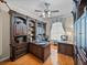 Home office with custom built-in shelves, wood desk, and hardwood floors at 152 Melissa Trl, Auburndale, FL 33823