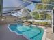 Backyard pool features a rock waterfall, mature landscaping, and a white privacy fence at 152 Melissa Trl, Auburndale, FL 33823