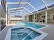 Covered pool with hot tub and spa showing covered patio with columns and ceiling fan at 152 Melissa Trl, Auburndale, FL 33823