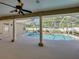 View of the patio, pool, and rock waterfall surrounded by white privacy fence and plants at 152 Melissa Trl, Auburndale, FL 33823