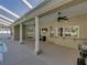 View of the travertine-tiled patio with ceiling fans, a serving bar, and a pool view at 152 Melissa Trl, Auburndale, FL 33823