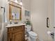 Well-maintained powder room featuring custom vanity, granite counter and decorative accents at 152 Melissa Trl, Auburndale, FL 33823
