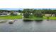 Waterfront property with a private dock, lush green lawn, and a serene lake view at 152 Melissa Trl, Auburndale, FL 33823