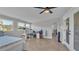 Bedroom features a ceiling fan, tile floor, and large windows overlooking the yard at 1535 Walker Rd, Lakeland, FL 33810