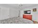 Bright bedroom featuring a queen bed, red dresser, modern lighting, and closet at 1619 Salesberry St, Lakeland, FL 33803