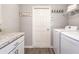 Functional laundry room with modern appliances, a folding counter, and ample storage space at 1827 Daystar Dr, Haines City, FL 33844