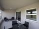 Covered patio with outdoor seating, sliding glass doors, and a view of the backyard at 1827 Daystar Dr, Haines City, FL 33844