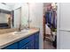 Bathroom featuring a single sink vanity and an open closet with clothes hanging in it at 1880 N Crystal Lake Dr # 35, Lakeland, FL 33801