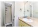 Cozy bathroom featuring a walk-in shower, vanity with cream countertop, and white tiled walls at 1880 N Crystal Lake Dr # 35, Lakeland, FL 33801