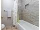 Modern bathroom with tiled bathtub and shower featuring a decorative shower curtain at 1880 N Crystal Lake Dr # 35, Lakeland, FL 33801