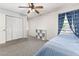 Cozy bedroom featuring neutral carpet, a closet, and a window with patterned curtains at 1880 N Crystal Lake Dr # 35, Lakeland, FL 33801