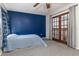 Comfortable bedroom featuring a blue wall, French doors, carpet flooring, and bright natural light at 1880 N Crystal Lake Dr # 35, Lakeland, FL 33801