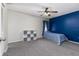 Calm bedroom with a blue accent wall, a ceiling fan, and a closet for optimal storage solutions at 1880 N Crystal Lake Dr # 35, Lakeland, FL 33801