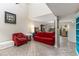 Inviting living room featuring tile flooring, high ceilings, and comfortable seating arrangements at 1880 N Crystal Lake Dr # 35, Lakeland, FL 33801