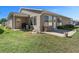 Back exterior with siding, well-kept lawn, back patio and landscaping at 1939 Prairie Dunes N Cir, Lakeland, FL 33810