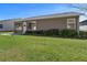 Back exterior with siding, well-kept lawn and landscaping at 1939 Prairie Dunes N Cir, Lakeland, FL 33810