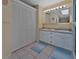 Bathroom featuring dual sinks, a vanity, a mirror, and ample storage space in the closet at 1939 Prairie Dunes N Cir, Lakeland, FL 33810