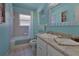 Bright bathroom featuring a tub with shower, and a vanity with solid surface countertops at 1939 Prairie Dunes N Cir, Lakeland, FL 33810
