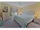 Cozy bedroom with comfortable bed, bedside tables, and a window that provides natural light at 1939 Prairie Dunes N Cir, Lakeland, FL 33810