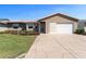 Charming single-story home with well-maintained landscaping, neutral siding, and a two-car garage at 1939 Prairie Dunes N Cir, Lakeland, FL 33810