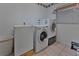 Functional laundry room with modern washer and dryer, with space for a freezer at 1939 Prairie Dunes N Cir, Lakeland, FL 33810