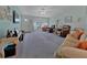 Open living room with neutral carpet, a ceiling fan, and a view to the front entrance at 1939 Prairie Dunes N Cir, Lakeland, FL 33810