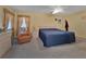 Comfortable main bedroom with a ceiling fan, neutral carpet, and a view to a window with lots of light at 1939 Prairie Dunes N Cir, Lakeland, FL 33810