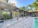 A covered outdoor living space featuring seating, dining, and a grill alongside an in-ground pool at 2605 Nevada Rd, Lakeland, FL 33803