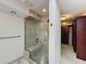 This bathroom offers a glass enclosed shower with a built-in bench and well lit walk-in closet at 2605 Nevada Rd, Lakeland, FL 33803