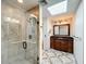 Bathroom featuring a glass-enclosed shower, skylight, and vanity with a dark countertop at 2605 Nevada Rd, Lakeland, FL 33803