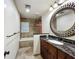 Bathroom featuring a granite vanity, decorative mirror, and a tub with decorative shower curtain at 2605 Nevada Rd, Lakeland, FL 33803