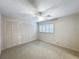 Bright bedroom featuring a ceiling fan, a window with shutters, and a closet with paneled doors at 2605 Nevada Rd, Lakeland, FL 33803