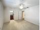 Bedroom with neutral carpet, fan, and view of attached bathroom and another room at 2605 Nevada Rd, Lakeland, FL 33803