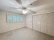 Bright bedroom with neutral carpet, large closet and natural light from shuttered windows at 2605 Nevada Rd, Lakeland, FL 33803