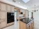 A modern kitchen featuring granite countertops, a central island, and lots of custom cabinetry at 2605 Nevada Rd, Lakeland, FL 33803
