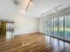 Bright living room featuring hardwood floors, track lighting, and window shutters at 2605 Nevada Rd, Lakeland, FL 33803