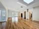 Spacious living room featuring hardwood floors, track lighting, skylight, and window shutters at 2605 Nevada Rd, Lakeland, FL 33803