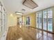 Spacious living room with hardwood floors, custom built-ins, and access to the outdoor pool area at 2605 Nevada Rd, Lakeland, FL 33803