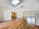 Open-concept living room featuring a skylight, hardwood floors, and shutters at 2605 Nevada Rd, Lakeland, FL 33803