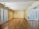 A spacious living room with hardwood floors, white beamed ceilings, and shuttered windows at 2605 Nevada Rd, Lakeland, FL 33803