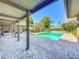 A backyard covered patio overlooks the in-ground pool at 2605 Nevada Rd, Lakeland, FL 33803