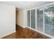 Bright sunroom with tile flooring and shuttered doors with views of the lush outdoors at 2605 Nevada Rd, Lakeland, FL 33803
