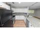 Bright kitchen featuring white cabinets, stainless steel appliances and granite countertops at 2735 Aldine Cir, Lakeland, FL 33801