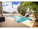 Large backyard pool with slide and basketball hoop, surrounded by lush landscaping at 2814 Sheldon St, Lakeland, FL 33813