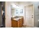 Bathroom with a single sink vanity, a decorative mirror, and white doors and trim at 2814 Sheldon St, Lakeland, FL 33813