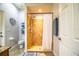 Well-lit bathroom showcasing a walk-in shower with a shower curtain, a toilet and neutral colored tile at 2814 Sheldon St, Lakeland, FL 33813